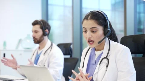 Team of doctors in headset working in online call center healthcare service usin Stock-Footage 309011240