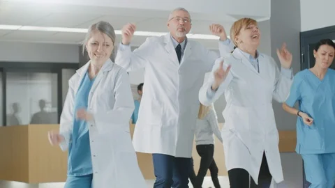 Team of Doctors, Nurses and Assistants Dances After Successful Procedure Stock Footage