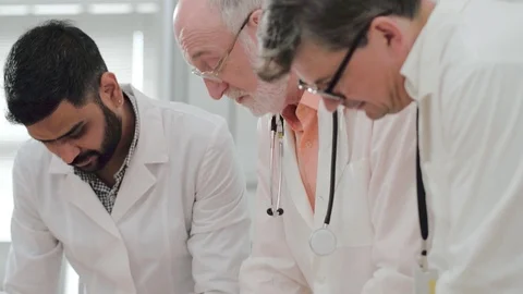 Team of doctors oncologists working together in clinic Видео 98869582