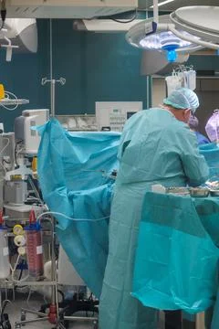 A team of doctors performs an operation in a clinic Stock Photos