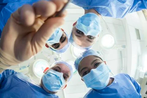 Team doctors surgeons operating theater fisheye Stock Photos