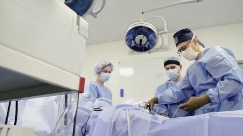 A team of doctors - surgeons performing a surgical operation Stockbeeldmateriaal 269481124