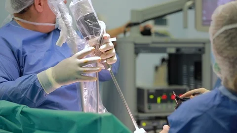 Team of doctors using laparoscopy camera surgery robot in surgical room in ho Stock Footage
