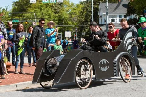 Team Dressed Like Batman Characters Push Bed In Fundraiser Event Stock Photos