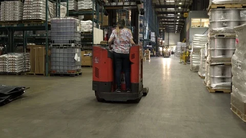 Team driving and operating machinery by warehouse aisle. 動画素材 88028788