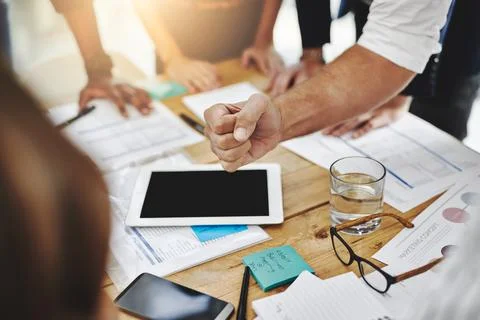 Team effort is essential. a group of unrecognizable people working together in a Stock Photos
