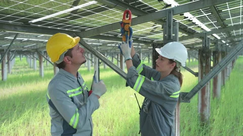A team of electrical engineers is inspecting and maintaining solar panels Stock Footage 255224381