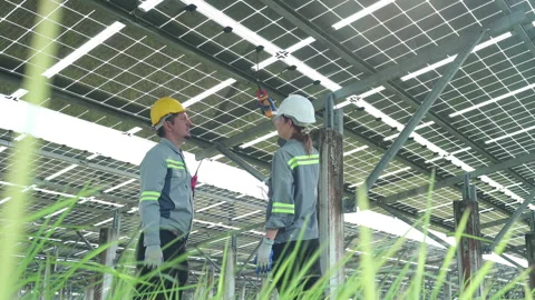 A team of electrical engineers is inspecting and maintaining solar panels Stock Footage 255260093