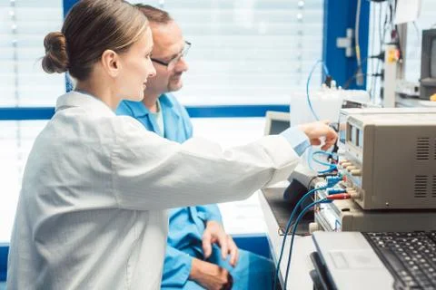 Team of electronic engineers testing a product prototype Stock Photos