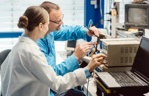 Team of electronic engineers testing a product prototype Stock Photos