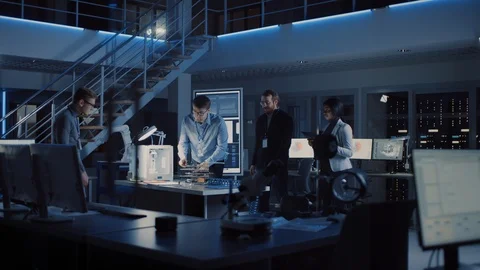 Team of Electronics Development Engineers Standing at the Desk with 3D Printer Stock Footage 104597428