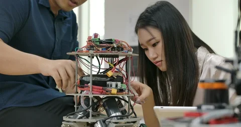 Team of electronics engineer works with robot. Video stock 111825353