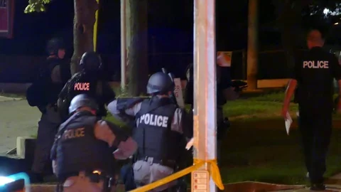 A Team of the Emergency Task Force walking to a scene Stock Footage 77887597