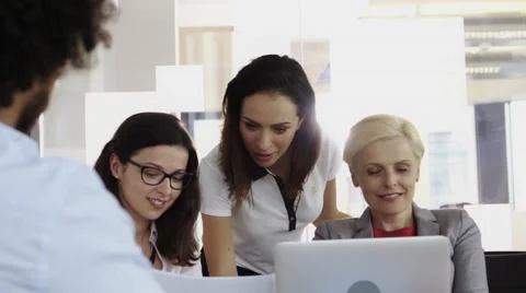 Team of employees working on computer together in their office Stock Footage 67346647