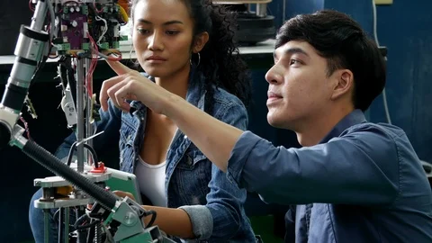 Team engineer collaborating on develop of robot project in workshop. Stock Footage 94277856