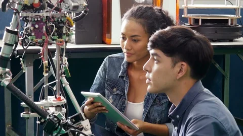 Team engineer collaborating on develop of robotics project in workshop. Video stock 94273130