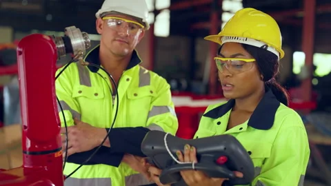 Team engineer controlling robot arm at factory. Stock Footage 231453968