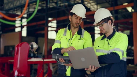 Team engineer examining and develop robot arm together at factory. Stock Footage 228866208