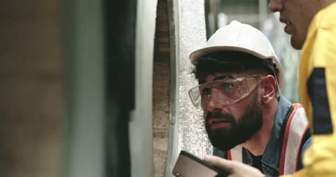 Team of engineer workers wearing safety helmets Use tablets to inspect steel Stock Footage 255004091