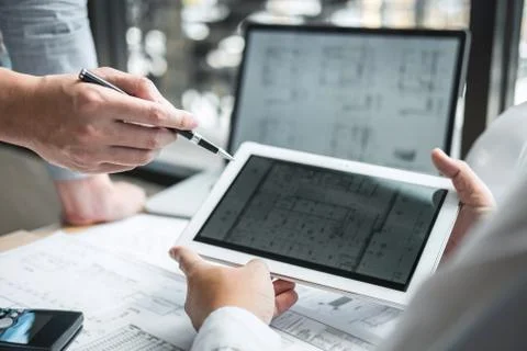 Team of engineering or architect meeting and discussing on blueprint and buil Stock Photos