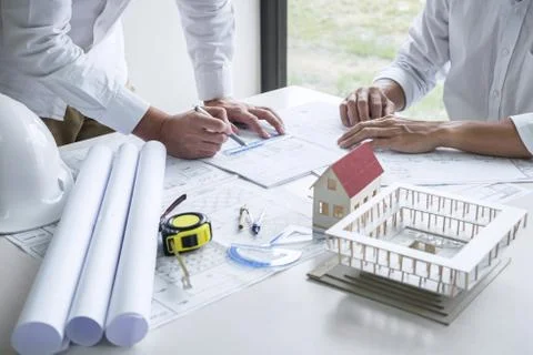 Team of engineering or architect meeting and discussing on blueprint and buil Stock Photos