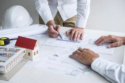 Team of engineering or architect meeting and discussing on blueprint and buil Stock Photos