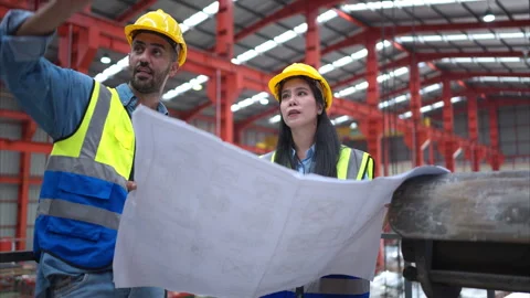 A team of engineers and architects are jointly inspecting factory at the site. Stock Footage 254764828