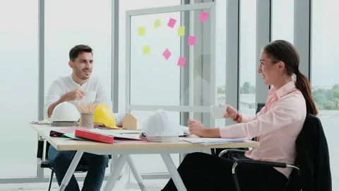 A team of engineers and architects meets at Brainstrom to work and discuss pr Stock Footage 153659220