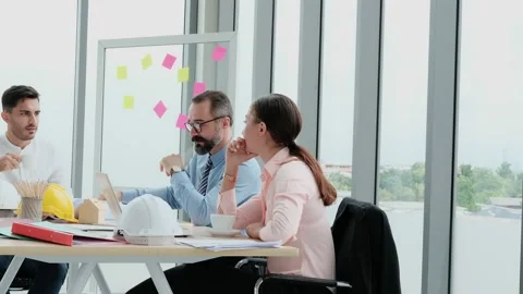 A team of engineers and architects meets at Brainstrom to work and discuss pr Stock Footage 153661415