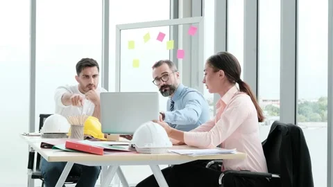 A team of engineers and architects meets at Brainstrom to work and discuss pr Stock Footage 153661932