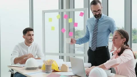 A team of engineers and architects meets at Brainstrom to work and discuss pr Stock Footage 153662327