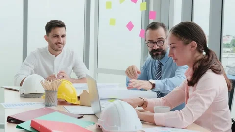 A team of engineers and architects meets at Brainstrom to work and discuss pr Stock Footage 153662575