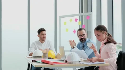 A team of engineers and architects meets at Brainstrom to work and discuss pr Stock Footage 153662998