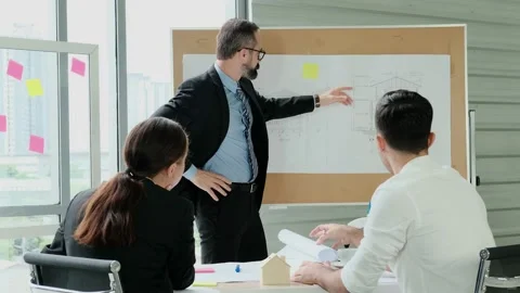 Team of engineers and architects work together in project brainstorm meeting. Stock Footage 153650667