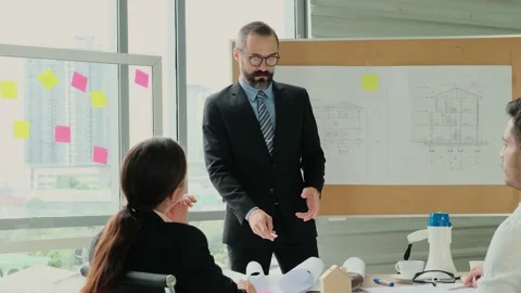 Team of engineers and architects work together in project brainstorm meeting. Stock Footage 153651903