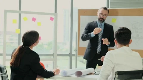 Team of engineers and architects work together in project brainstorm meeting. Stock Footage 153654951