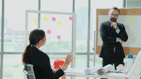 Team of engineers and architects work together in project brainstorm meeting. Stock Footage 153655881