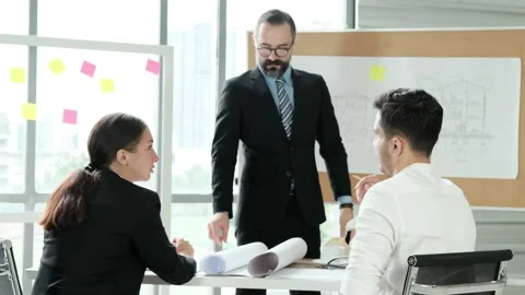 Team of engineers and architects work together in project brainstorm meeting. Stock Footage 153656130