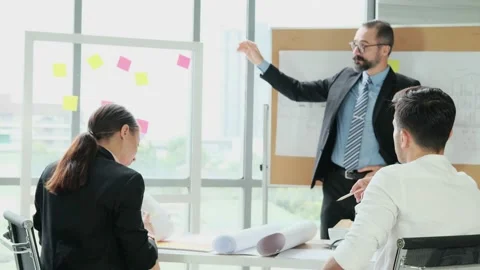 Team of engineers and architects work together in project brainstorm meeting. Stock Footage 153657195