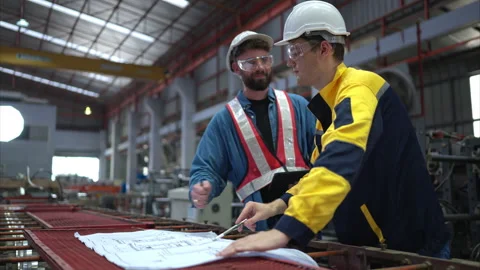 Team of engineers and architects working with blueprint at factory site. Stock Footage 254765580