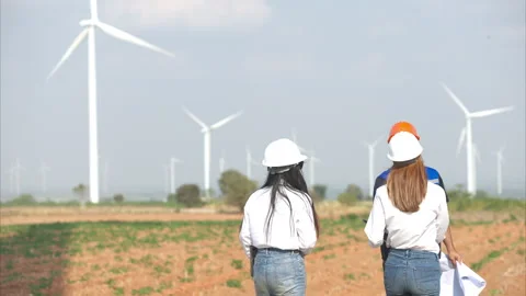 Team of engineers and architects working on wind turbines in a wind farm Stock Footage 264134540