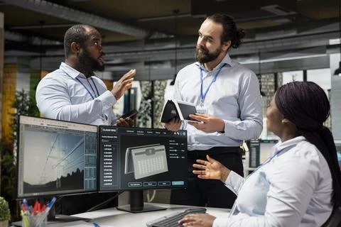 Team of engineers brainstorming upgrades for solar gadget to support green tech 스톡 사진