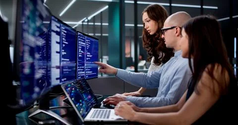 Team Of Engineers Collaborating On Software Development In Busy Office Stock Photos
