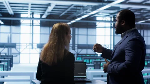 Team of engineers in data center doing brainstorming to fix problems Stock Footage 277654778