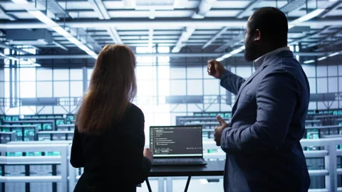 Team of engineers in data center doing brainstorming to fix problems Stock Footage 277657734