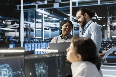 Team of engineers in data center integrating AI driven automation tools Stock Photos