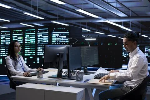 Team of engineers in data center making sure sensors are functioning 写真素材