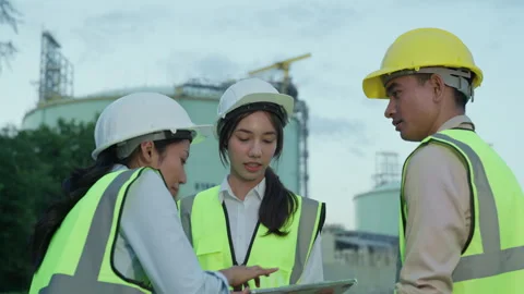 Team of engineers discussing project at site Stock Footage 293354744