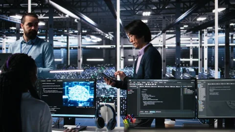 Team of engineers doing brainstorming in server room using AI Stock Footage 313567355