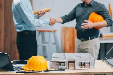 Team Engineers with draft plan of building on constructing site. Engineer w.. Fotos de archivo